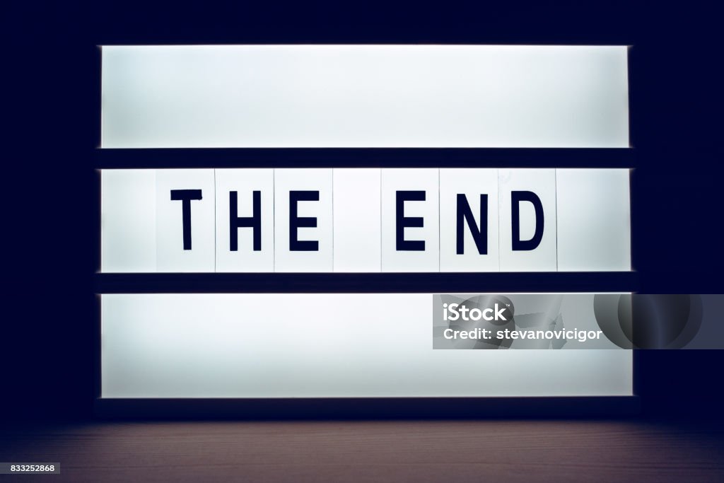 Blinking lightbox signage with The End text Blinking lightbox signage with The End text in dark room Film Industry Stock Photo