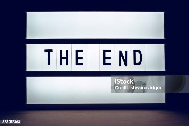 Blinking Lightbox Signage With The End Text Stock Photo - Download Image Now - Film Industry, Lightbox, Dark