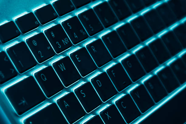istock Business workplace with computer wireless keyboard on blue table background. Office desk with copy space in blue tones 833253122