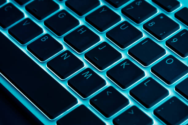 istock Business workplace with computer wireless keyboard on blue table background. Office desk with copy space in blue tones 833253148