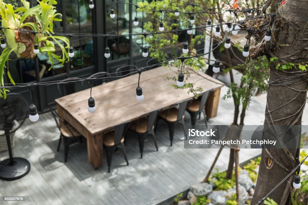 Dining table in backyard garden Dining table in backyard garden Focus on bulb Restaurant Stock Photo