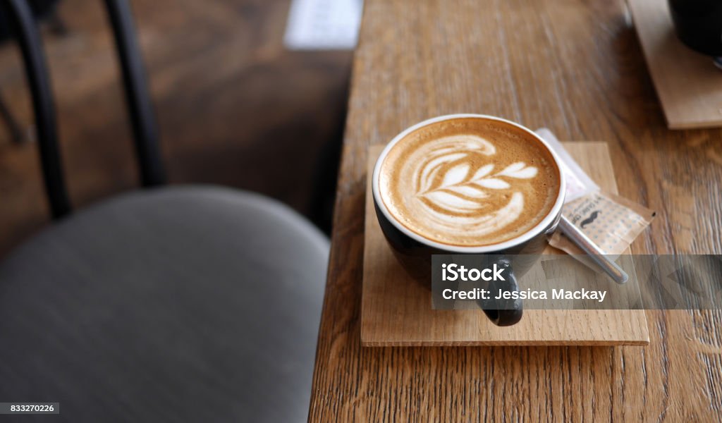 Flat White Coffee Flat white coffee in modern coffee shop Coffee Break Stock Photo