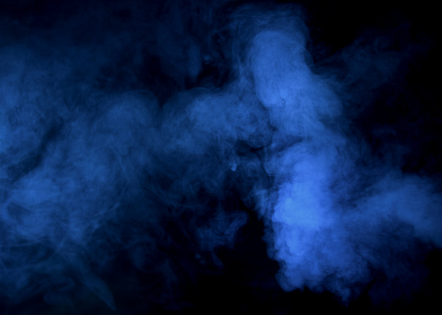 Abstract blue  smoke on a dark background. Blue  smoke background