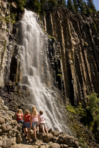 Kids standing looking at waterfall