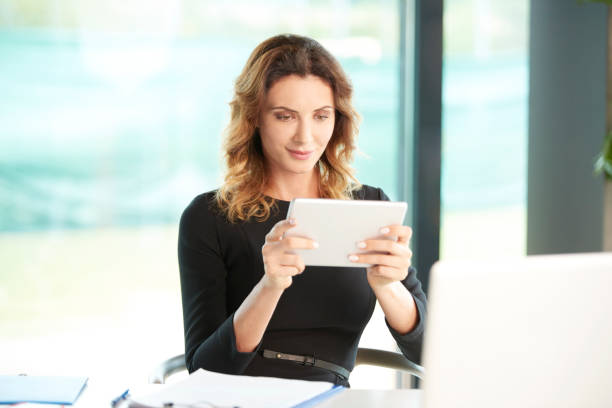 istock Young professional woman with digital tablet 833292242