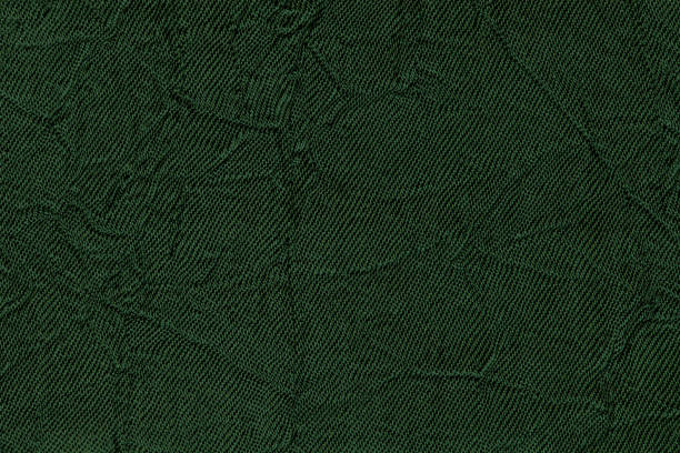 istock Dark green wavy background from a textile material. Fabric with fold texture closeup. 833294464