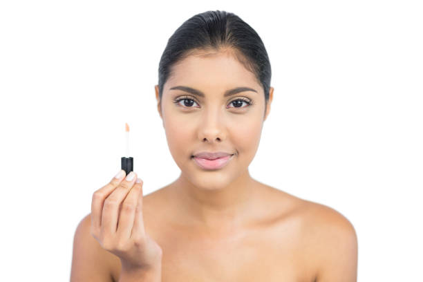 istock Pleased nude brunette holding lip gloss 833296816