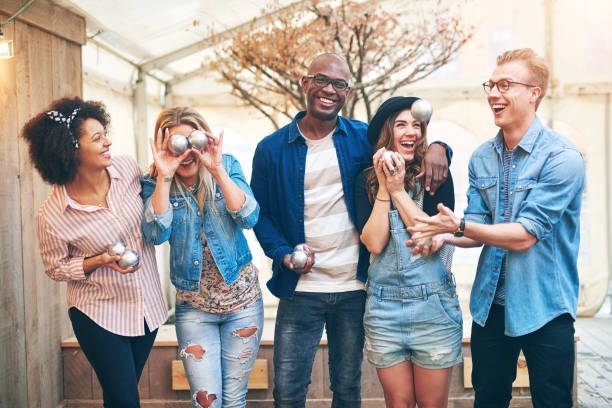 istock Man throwing up petanque ball having fun with friends 833299066