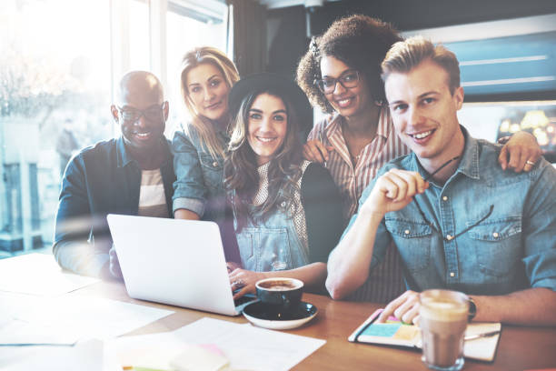istock Smiling group of coworkers in small office 833305014