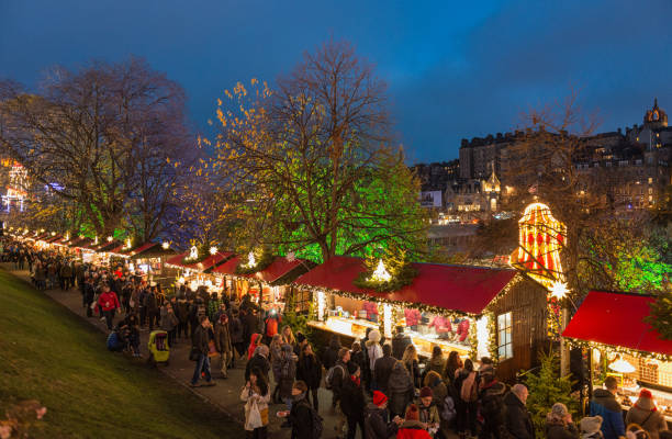 Christmas Market Stalls in Edinburgh Edinburgh, Scotland, UK - Crowds of shoppers and tourists browsing market stalls in Edinburgh's annual Winter Festival for Christmas and Hogmanay (New Year) in the city centre. hogmanay photos stock pictures, royalty-free photos & images