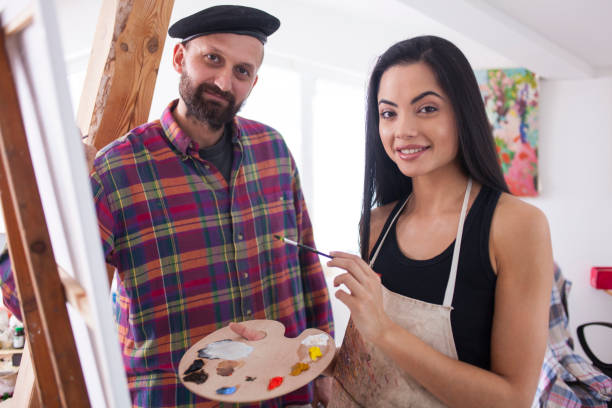 istock Teacher and female student posing in art school 833307948