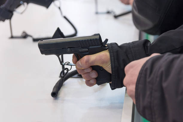 istock Gun is in the hand at the counter. Weapons 833315372