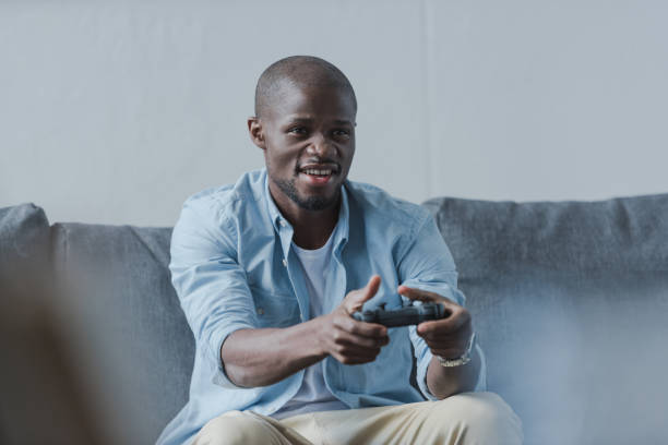 istock African american man playing with joystick 833322002