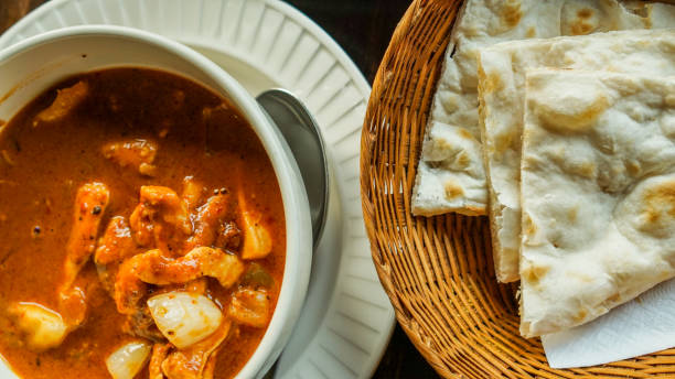 istock Indian cuisine red curry and nan roti bread 833329880