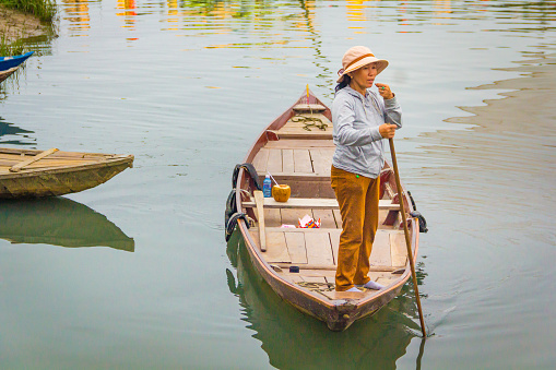 DaNang, Vietnam – March 12 2016: The woman driving her boat in the river, Hoi An, DaNang, VietNam