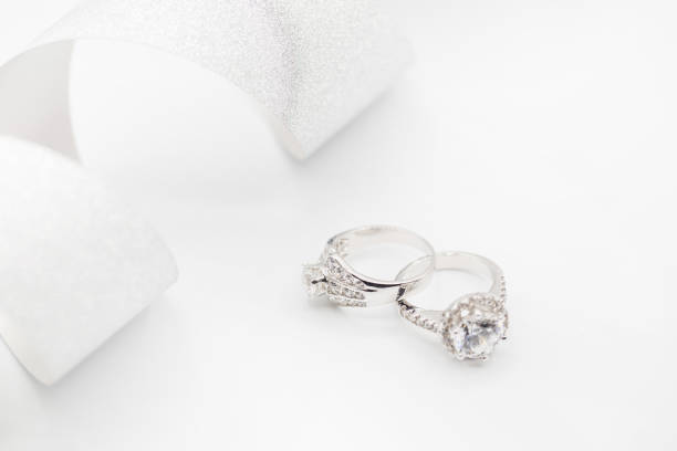 istock Diamond wedding rings on the white. selective focus 833369186