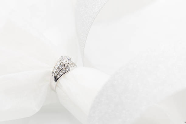 istock Diamond wedding rings on the white. selective focus 833369196