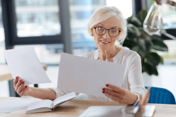 istock Positive delighted woman looking at the documents 833383132
