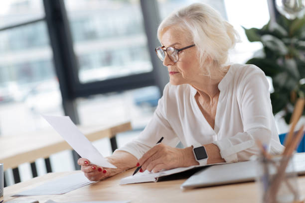 istock Serious experienced woman doing her job 833383300