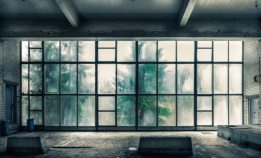 The view from an old, abandoned factory on the inside with nice window light
