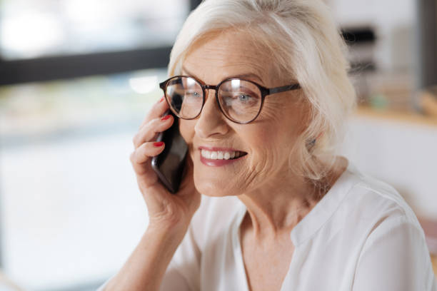 istock Joyful elderly woman having a phone conversation 833388730