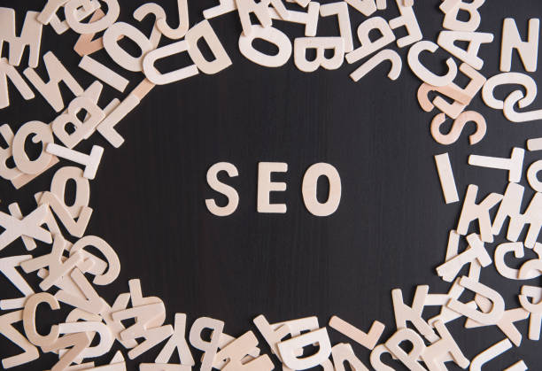 istock wood alphabet as SEO abbreviation (Search Engine Optimization) on table. 833388910