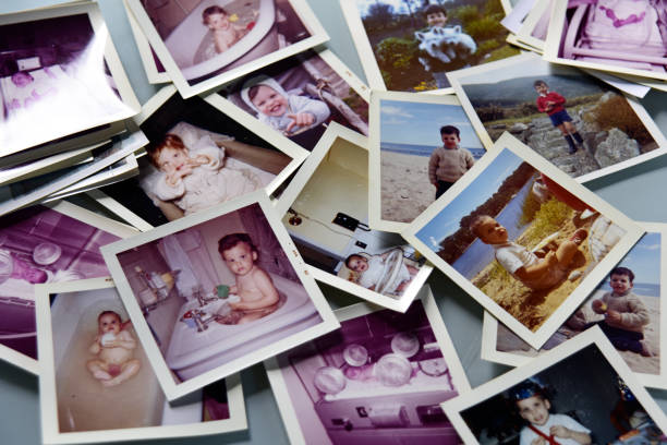 istock Photos of child (same one) spread out on white table. 833389310