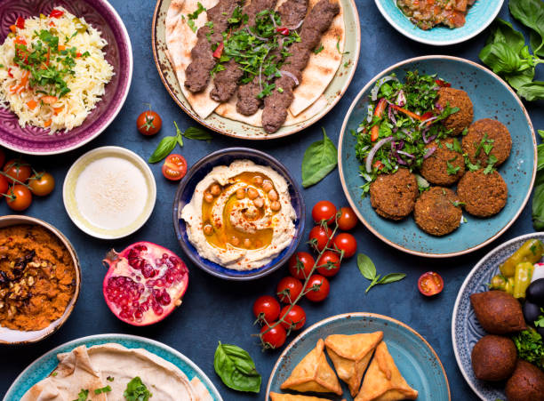 Arabic dishes and meze Middle eastern or arabic dishes and assorted meze, concrete rustic background. Meat kebab, falafel, baba ghanoush, muhammara, hummus, sambusak, rice, tahini, kibbeh, pita. Halal food. Lebanese cuisine middle eastern food photos stock pictures, royalty-free photos & images