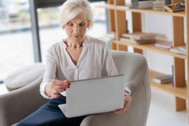 istock Nice concentrated woman opening her laptop 833393582