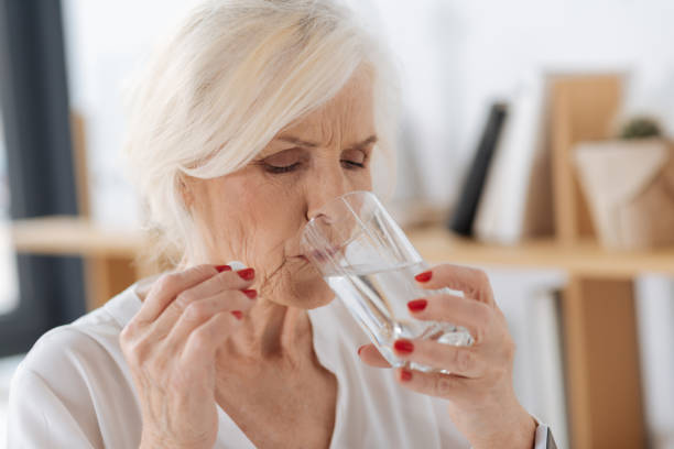 istock Nice elderly woman drinking water 833395460