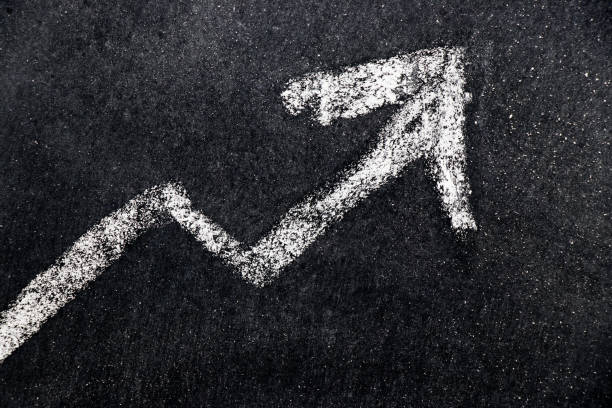 istock White chalk draw as upward arrow graph on black board background (Concept for sale, profit, cost of company in uptrend) 833395544