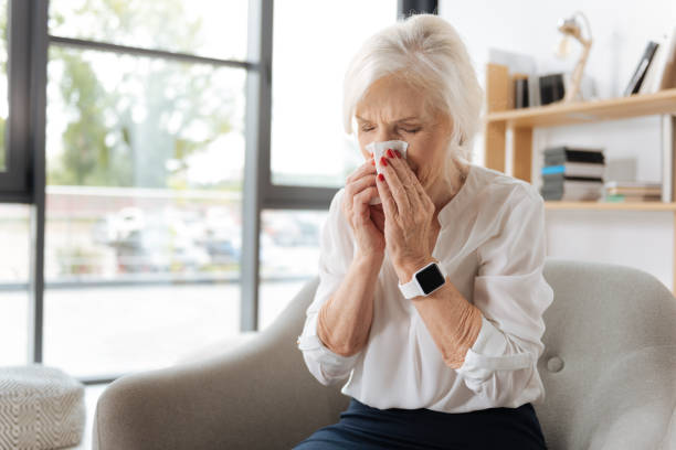 istock Unhappy elderly woman sneezing 833400768