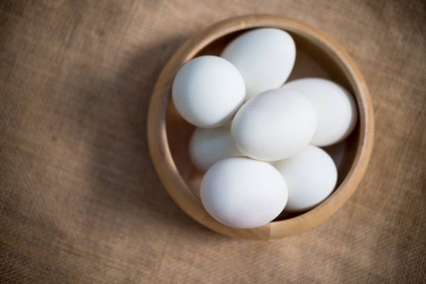 istock Salted duck egg in a wooden bowl on sackcloth, top view 833402872