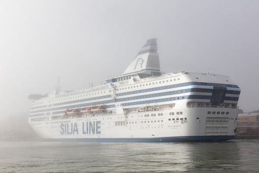 Helsinki, Finland, - August  11, 2017: Silja Line ship Silja Symphony docked in a heavy fog at Katajanokka Terminal in Helsinki, Finland