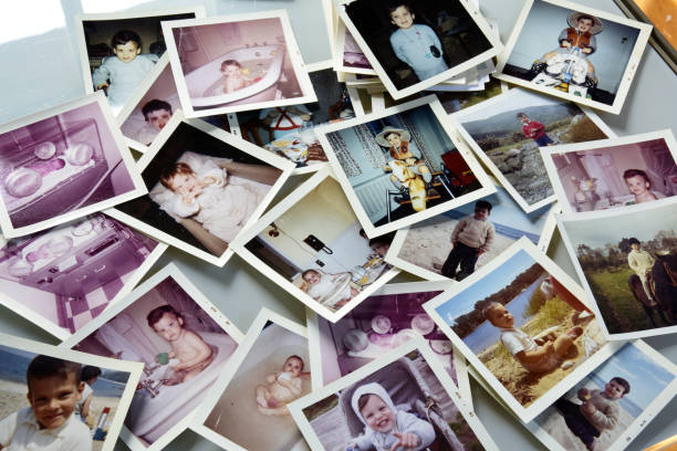 istock Photos of child (same one) spread out on white table. 833430376
