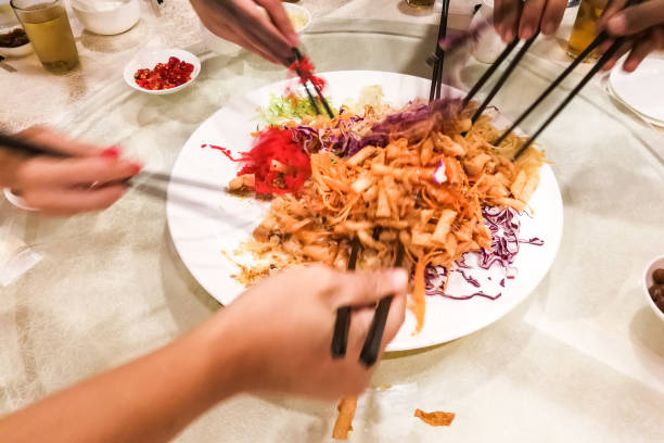 istock Motion hands with chopsticks tossing  Yee Sang meal in Malaysia 833446582