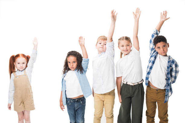 istock multiethnic group of children raising hands and looking at camera isolated on white 833454080