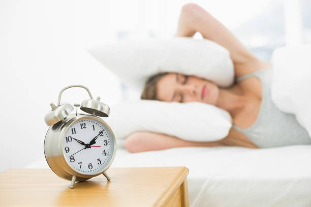 istock Pretty woman holding her ears closed by using pillows 833462704
