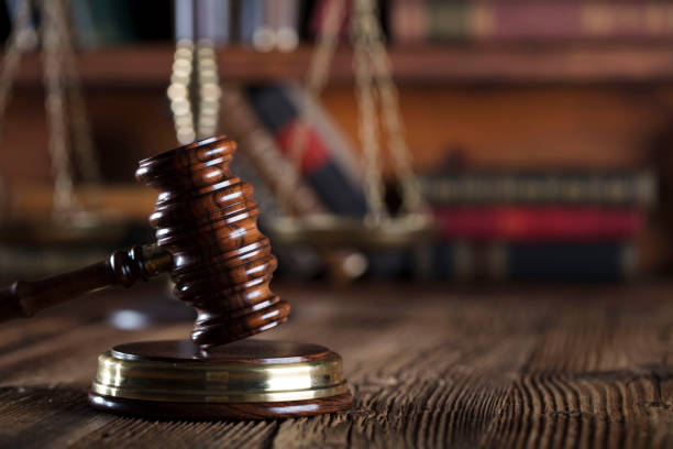 istock Judges gavel. Books. Wooden table 833487600