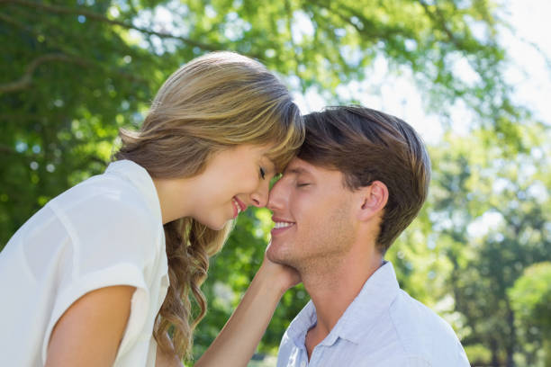 istock Cute couple facing each other in the park 833489172