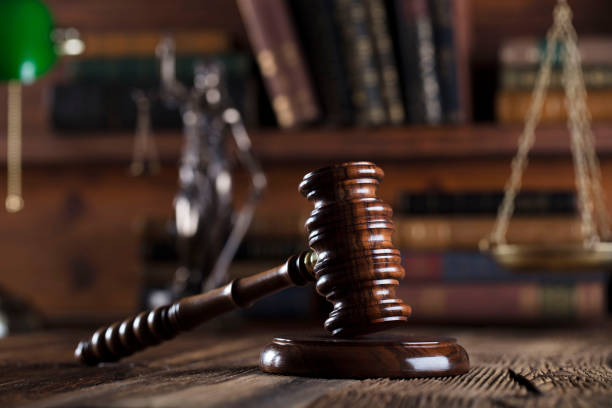 istock Judges gavel. Books. Wooden table 833495106
