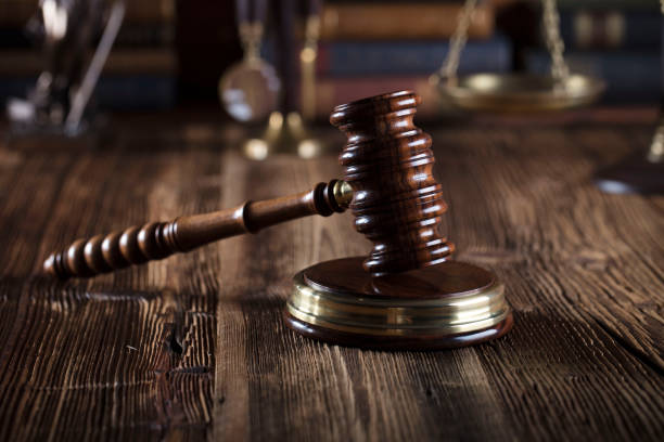istock Judges gavel. Books. Wooden table 833495108