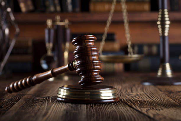 istock Judges gavel. Books. Wooden table 833495396