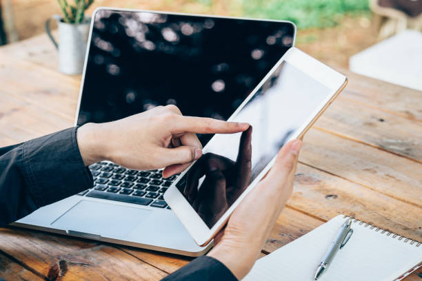 istock business man using tablet on wood table in coffee shop. 833496364