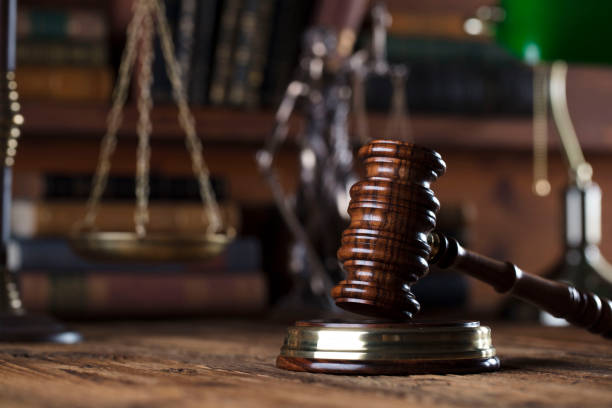 istock Judges gavel. Books. Wooden table 833496416