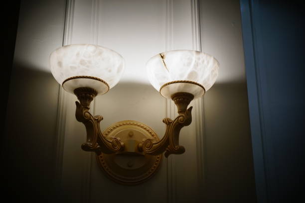 istock Antique Lighting Fixture Against Old Patterned Wallpaper 833504986