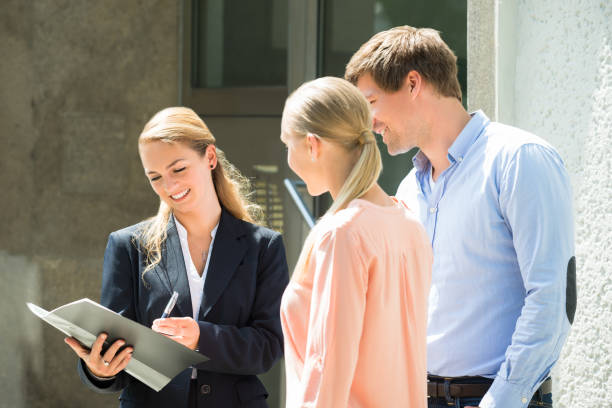 istock Real Estate Agent Explaining Contract To Couple 833509462
