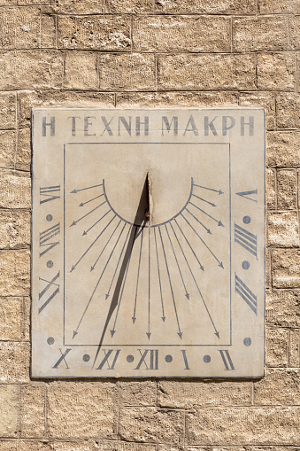 Old sundial in a stone facade, Montpellier, France