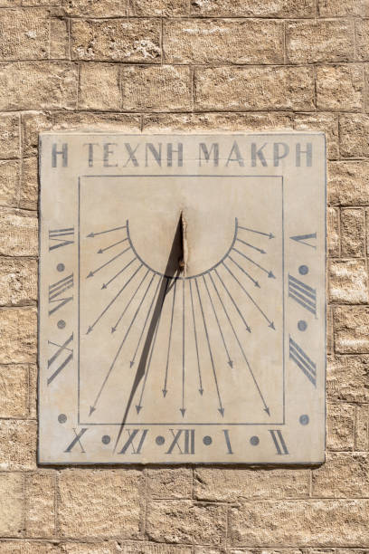Old sundial in a stone facade Old sundial in a stone facade, Montpellier, France ancient sundial stock pictures, royalty-free photos & images