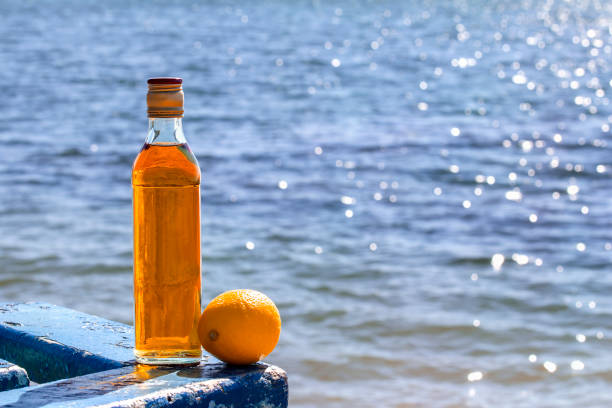 istock Bottle of whiskey and lemon on the table by lake 833517164